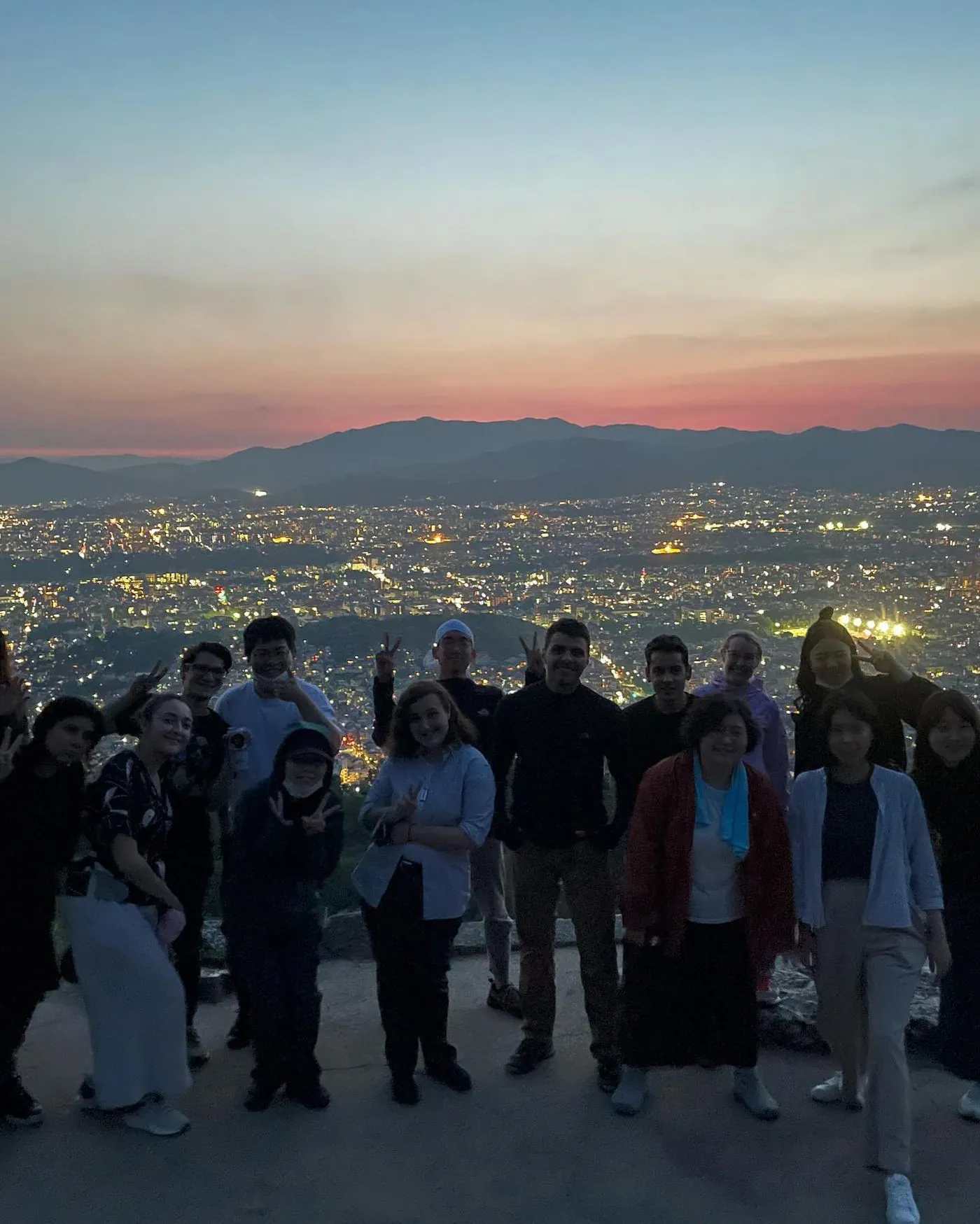Housemates at sunset above the lights of Kyoto