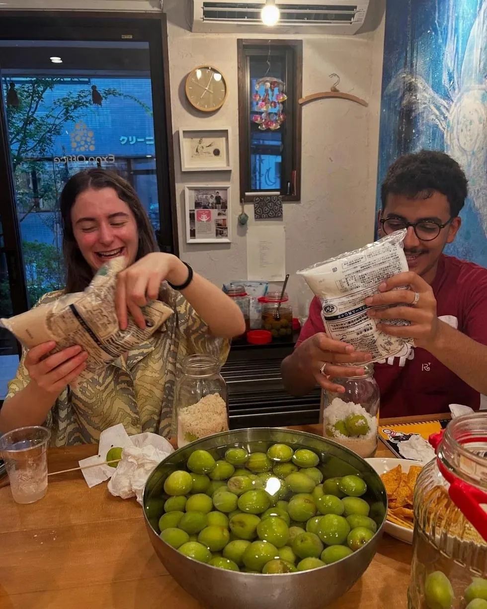 Housemates making plum wine together