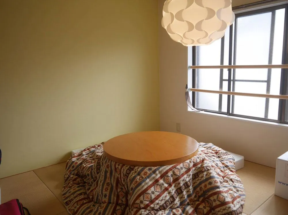 Tatami room with a kotatsu table at Rozan